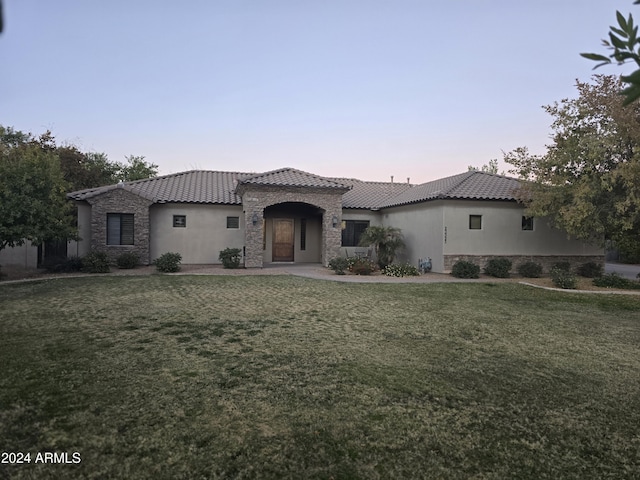 mediterranean / spanish house with a yard