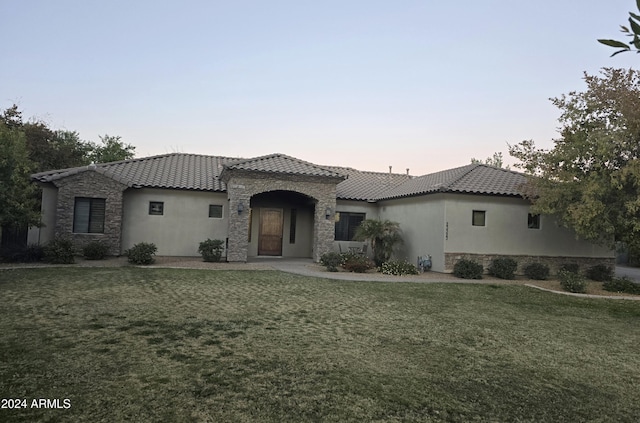 mediterranean / spanish-style home with a yard