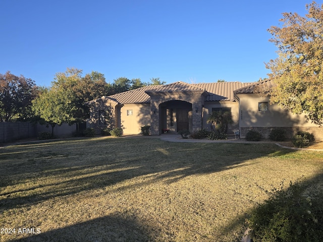 mediterranean / spanish-style home with a front lawn