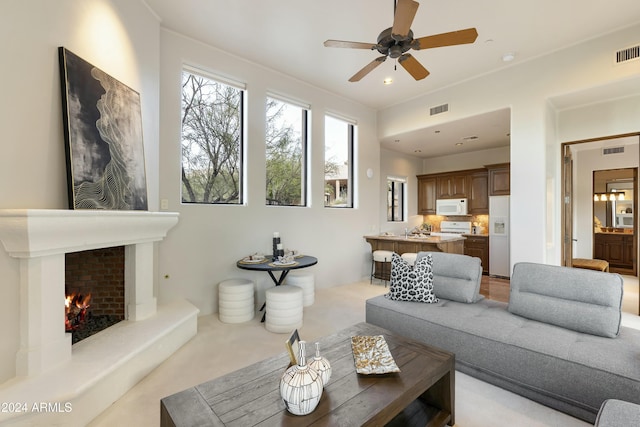 living room with ceiling fan and light carpet