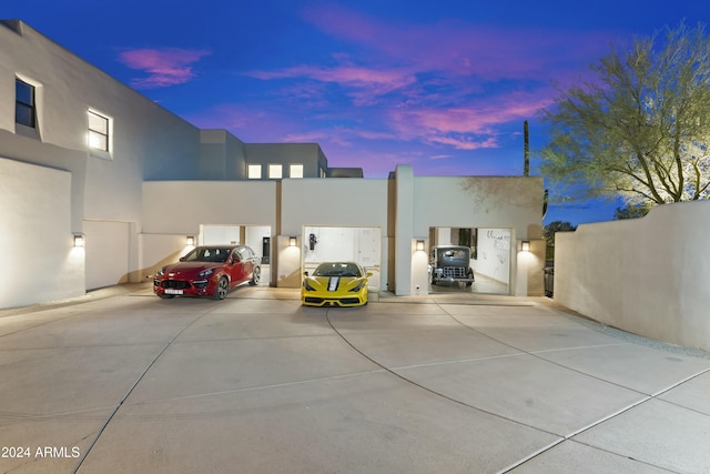 view of garage at dusk