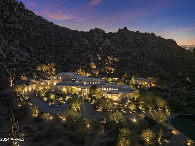 aerial view at dusk featuring a mountain view