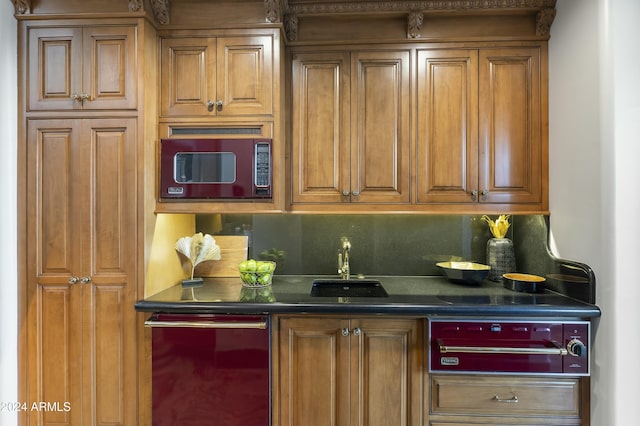 kitchen featuring backsplash, stainless steel dishwasher, and sink