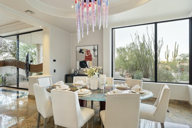 dining space with a tray ceiling and an inviting chandelier