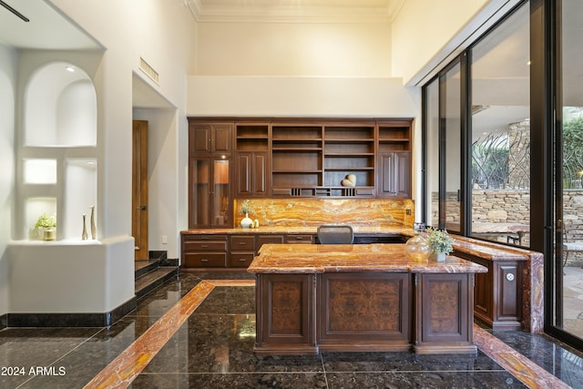 office space featuring a towering ceiling and ornamental molding