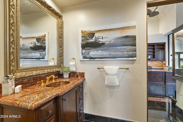 bathroom with backsplash, vanity, and ornamental molding