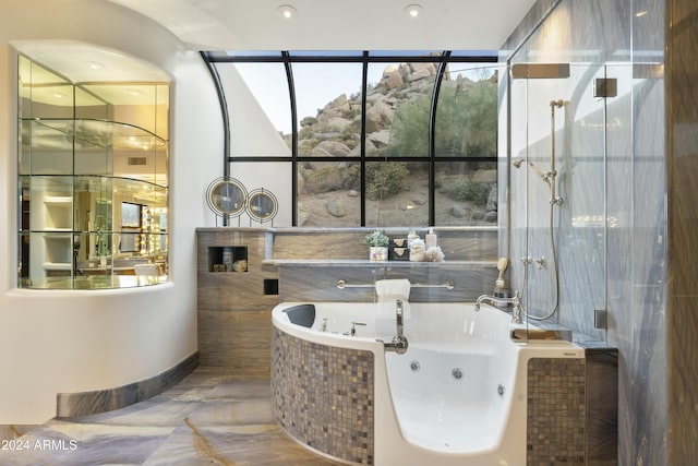 bathroom with a relaxing tiled tub