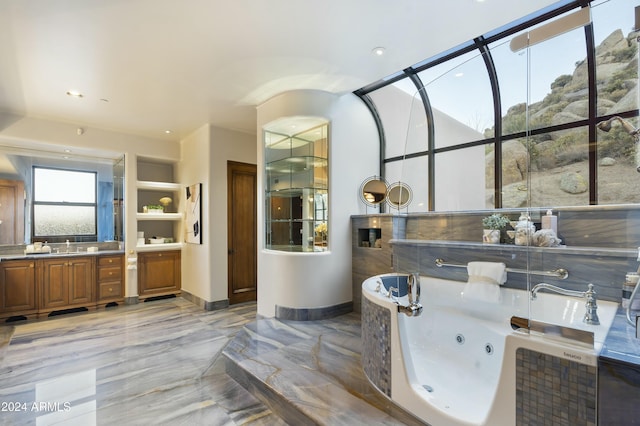 bathroom with a relaxing tiled tub and vanity