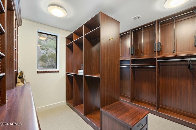 walk in closet featuring dark colored carpet