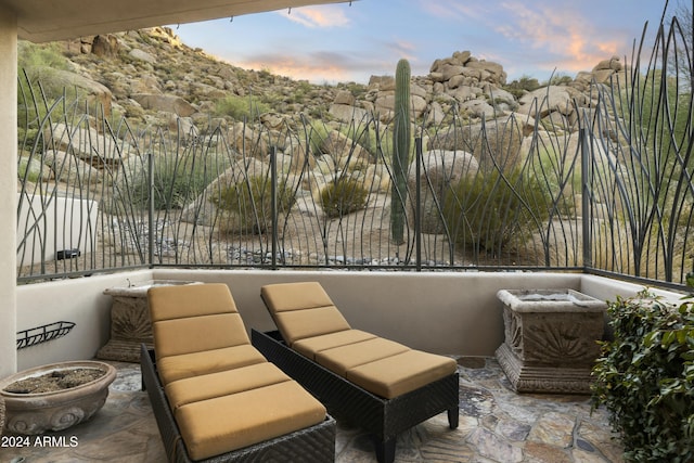 patio terrace at dusk with a balcony