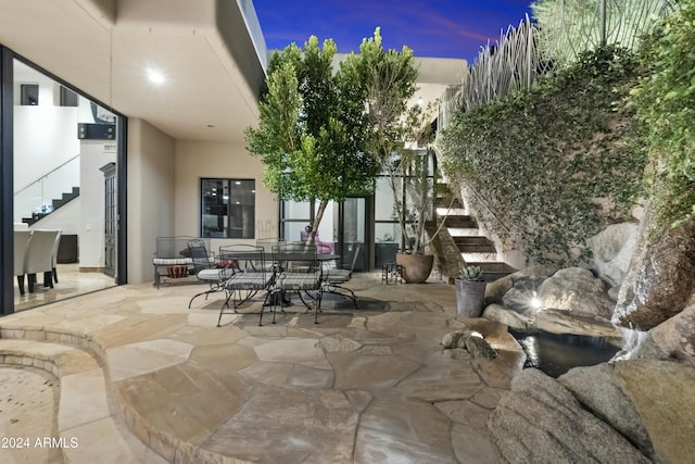 view of patio terrace at dusk