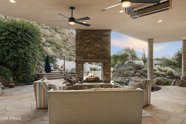 patio terrace at dusk featuring ceiling fan