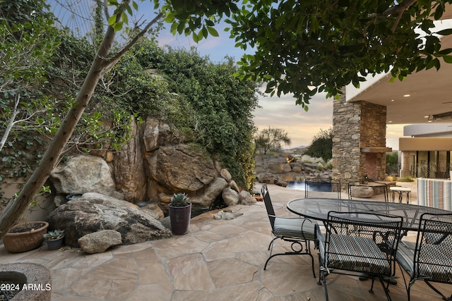 view of patio terrace at dusk