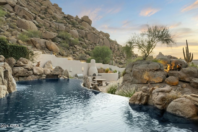 view of pool at dusk