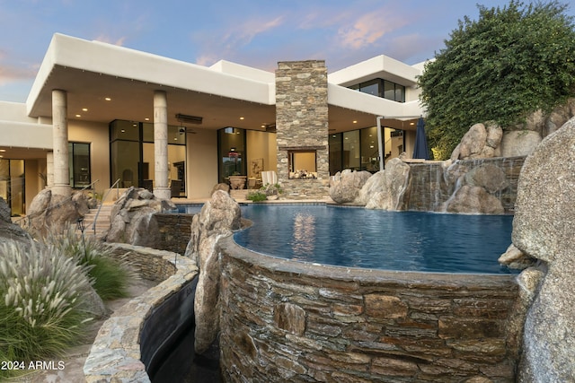 pool at dusk with pool water feature