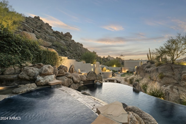 view of pool at dusk