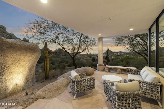 patio terrace at dusk with an outdoor living space