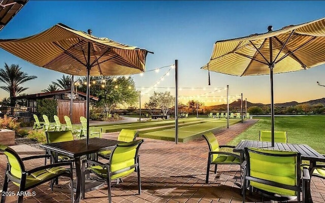 surrounding community with a yard and outdoor dining area