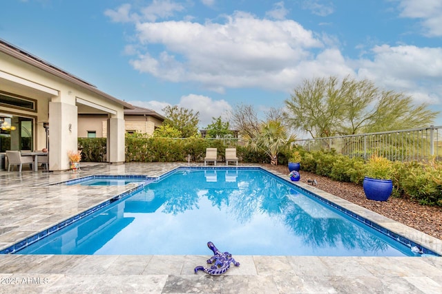 view of pool with a patio area, a fenced backyard, and a pool with connected hot tub