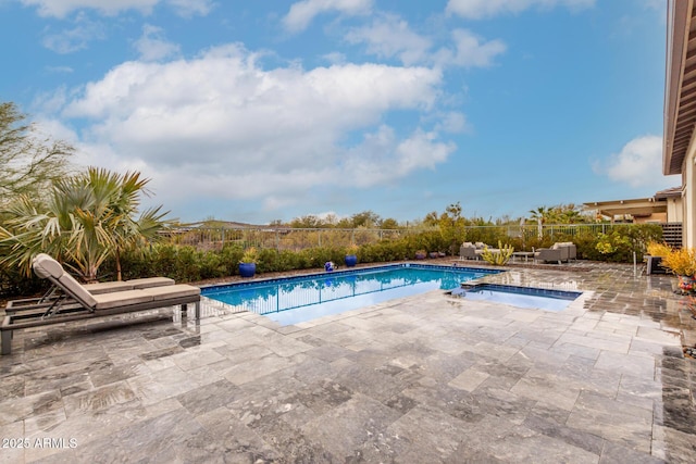 view of swimming pool with an in ground hot tub, a patio area, fence, and a fenced in pool