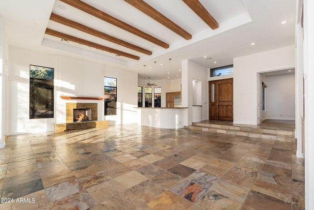 unfurnished living room featuring beam ceiling