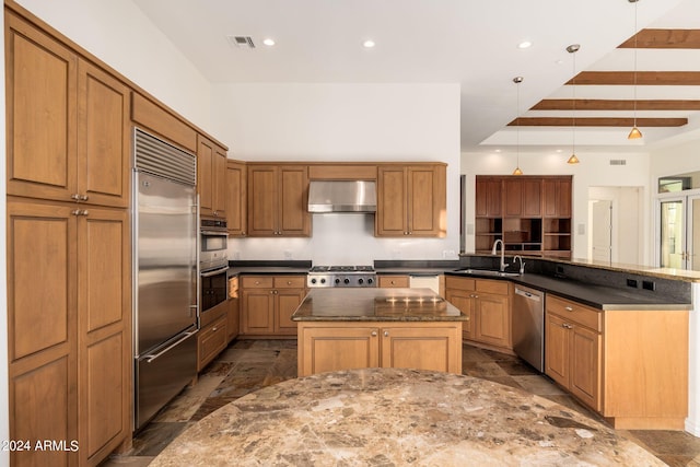 kitchen with appliances with stainless steel finishes, hanging light fixtures, kitchen peninsula, beam ceiling, and sink