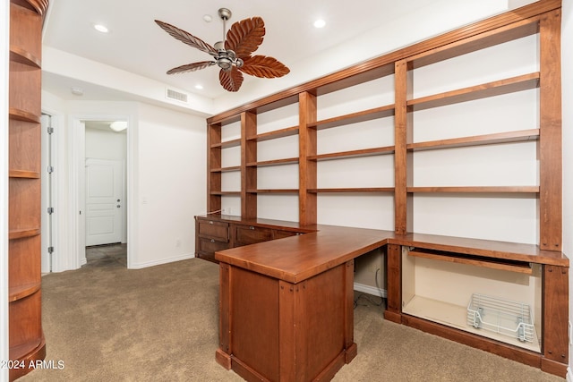 unfurnished office featuring dark carpet and ceiling fan