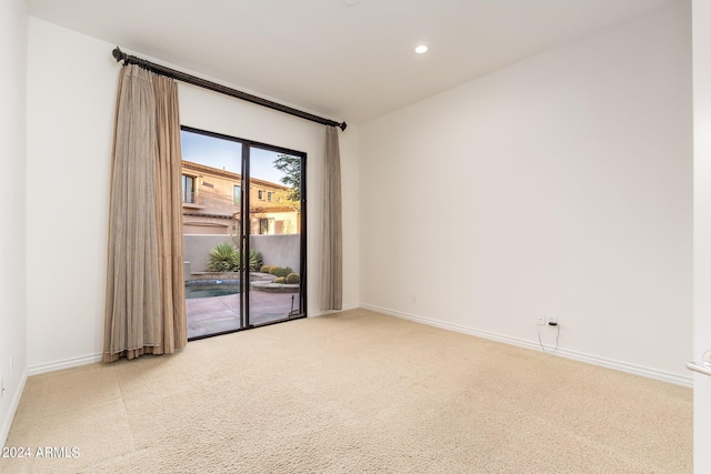 unfurnished room featuring light colored carpet