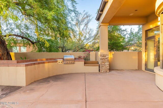 view of patio with area for grilling and an outdoor kitchen