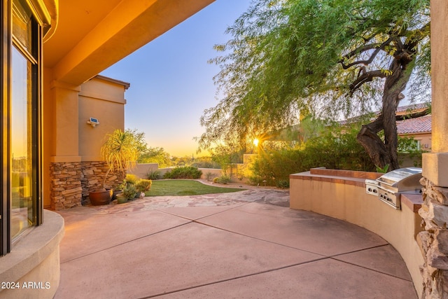 patio terrace at dusk with area for grilling and grilling area