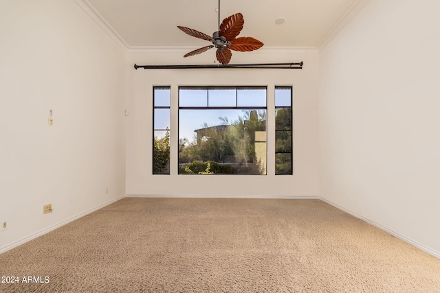 carpeted spare room featuring ornamental molding and ceiling fan