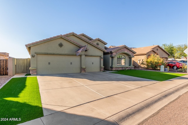 mediterranean / spanish home with a garage and a front yard