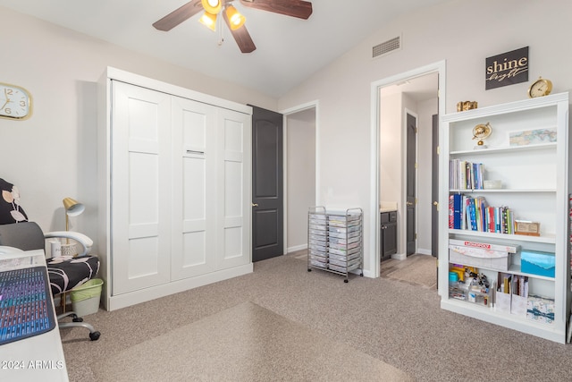 office area featuring lofted ceiling, ceiling fan, and light carpet