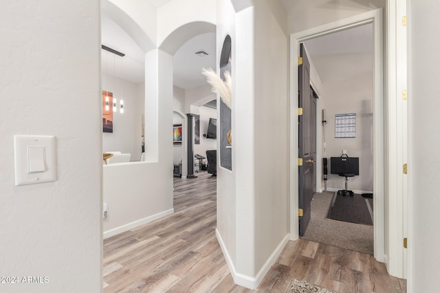 hallway with hardwood / wood-style flooring