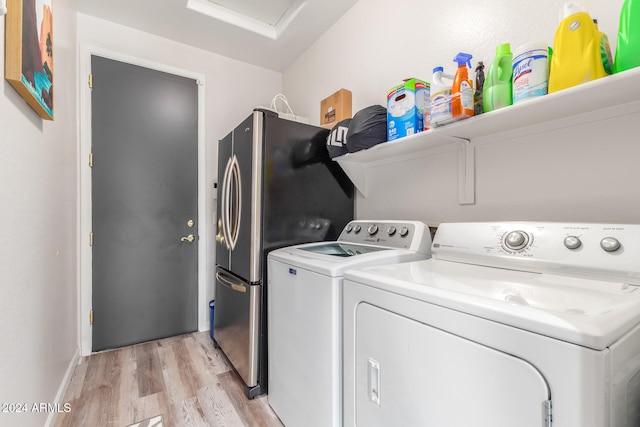 washroom featuring light hardwood / wood-style floors and separate washer and dryer