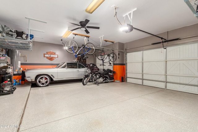 garage featuring a garage door opener, ceiling fan, and water heater