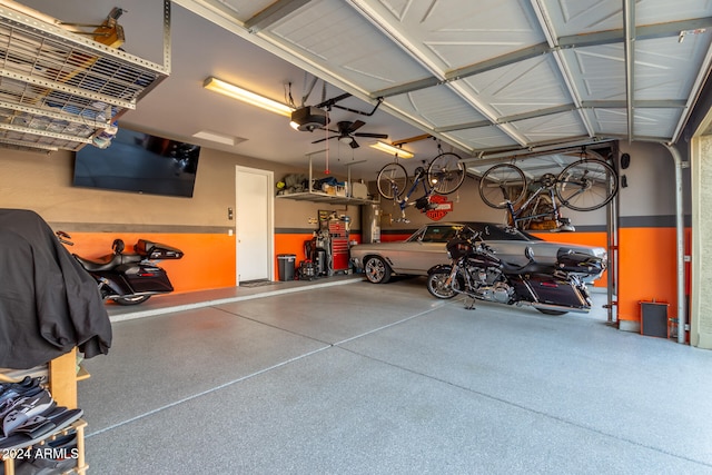 garage with a garage door opener and ceiling fan