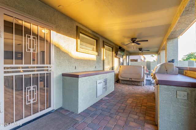 view of patio featuring ceiling fan and exterior kitchen