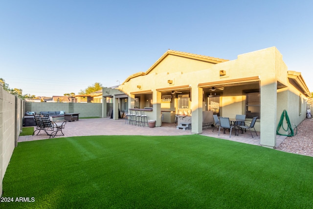 rear view of house featuring a patio area and a lawn