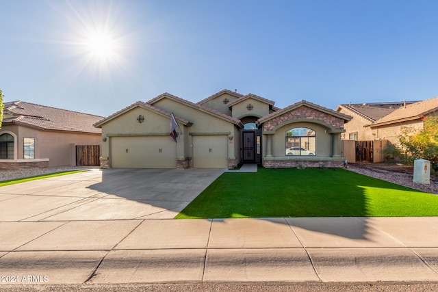 mediterranean / spanish-style house featuring a front lawn and a garage