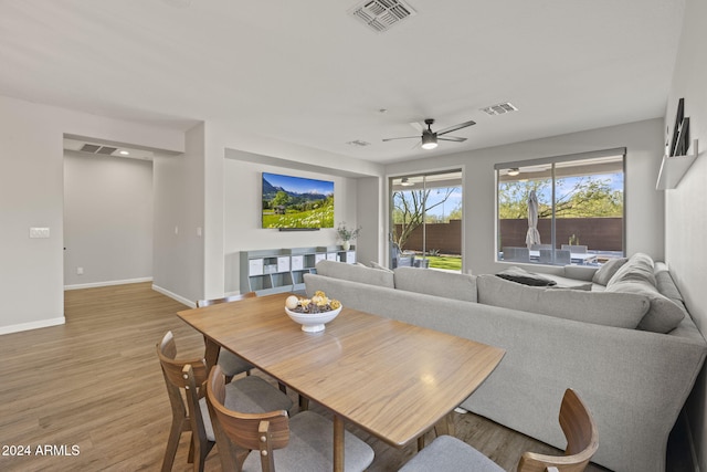 living room featuring ceiling fan and light hardwood / wood-style flooring