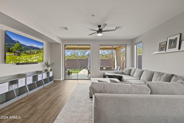 living room with hardwood / wood-style flooring and ceiling fan