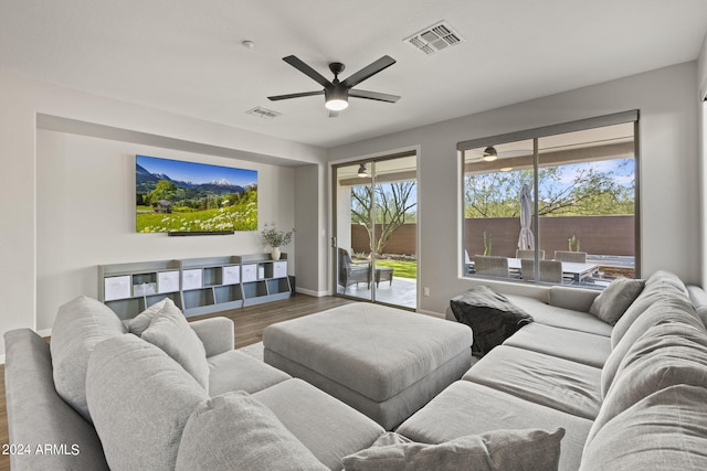 living room featuring ceiling fan and hardwood / wood-style flooring