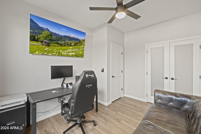 home office with ceiling fan and light hardwood / wood-style flooring