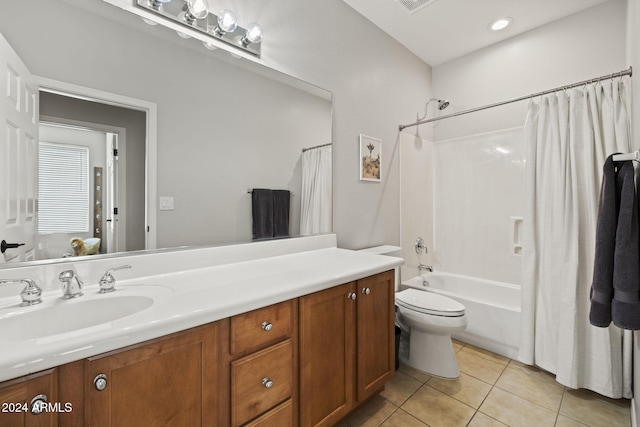 full bathroom featuring tile patterned floors, toilet, shower / tub combo with curtain, and vanity