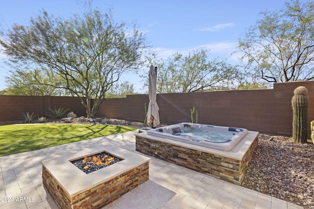 view of patio with an outdoor fire pit and an outdoor hot tub