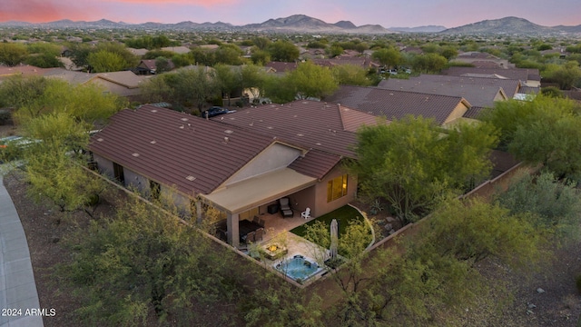 aerial view at dusk featuring a mountain view