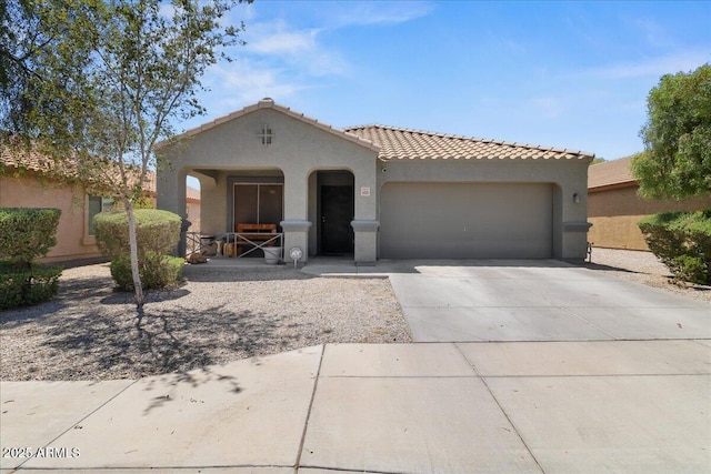 5026 S 235th Dr, Buckeye, AZ 85326 - mediterranean / spanish home featuring stucco siding, a garage, concrete driveway, and a tiled roof
