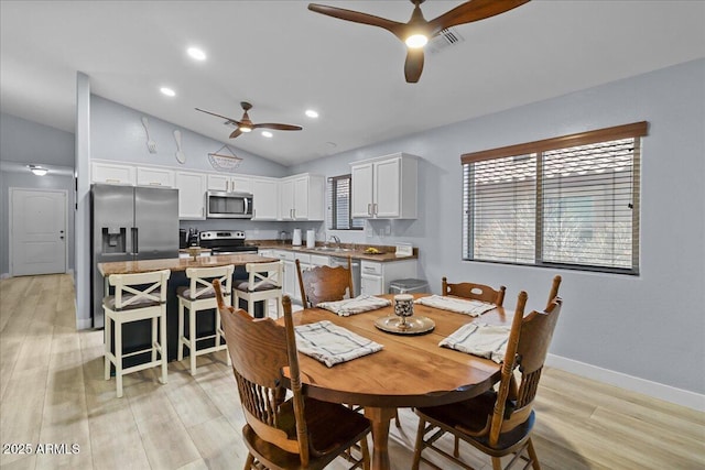 5026 S 235th Dr, Buckeye, AZ 85326 - dining room with ceiling fan, lofted ceiling, light wood-style floors, plenty of natural light, and recessed lighting