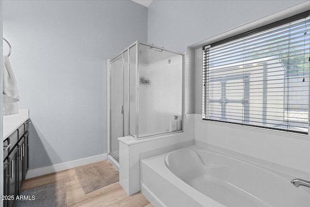 5026 S 235th Dr, Buckeye, AZ 85326 - full bathroom featuring a shower stall, vanity, a garden tub, and wood finished floors